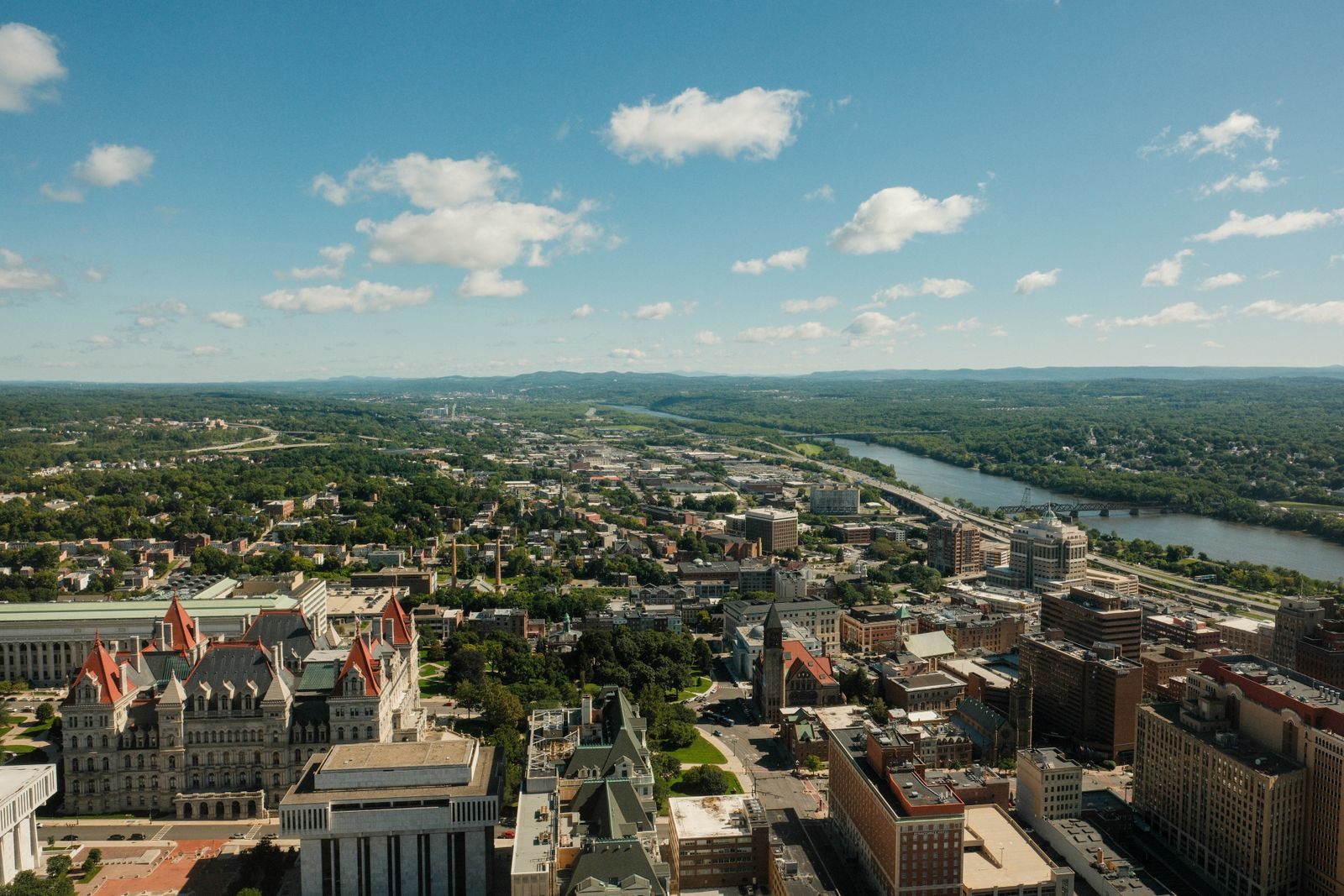 Aerial view over downtown Albany, with the New York State Capitol in the foreground and the Hudson River winding north
